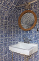 Mosaic Cobalt All all walls in a bathroom showing sink and mirror, Mirror shows more mosaic wallpaper. Photography by Geoffrey Hodgdon